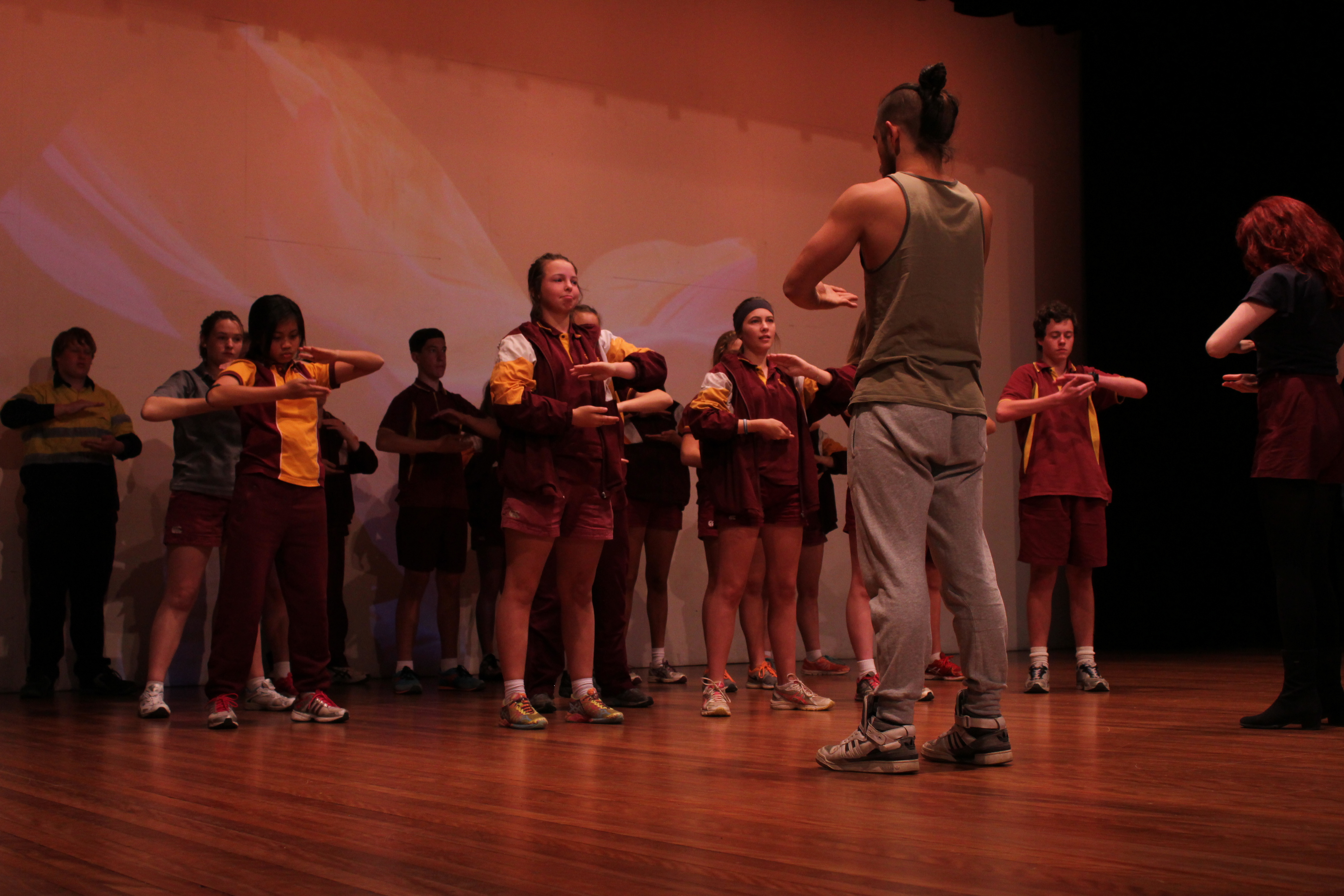 Photograph of teacher and students on stage